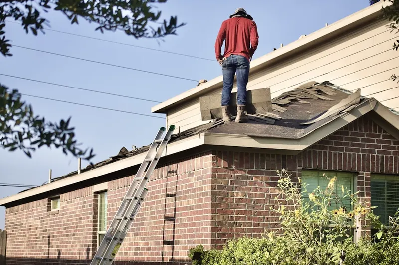 Professional roofer working on a residential roof in Federal Street